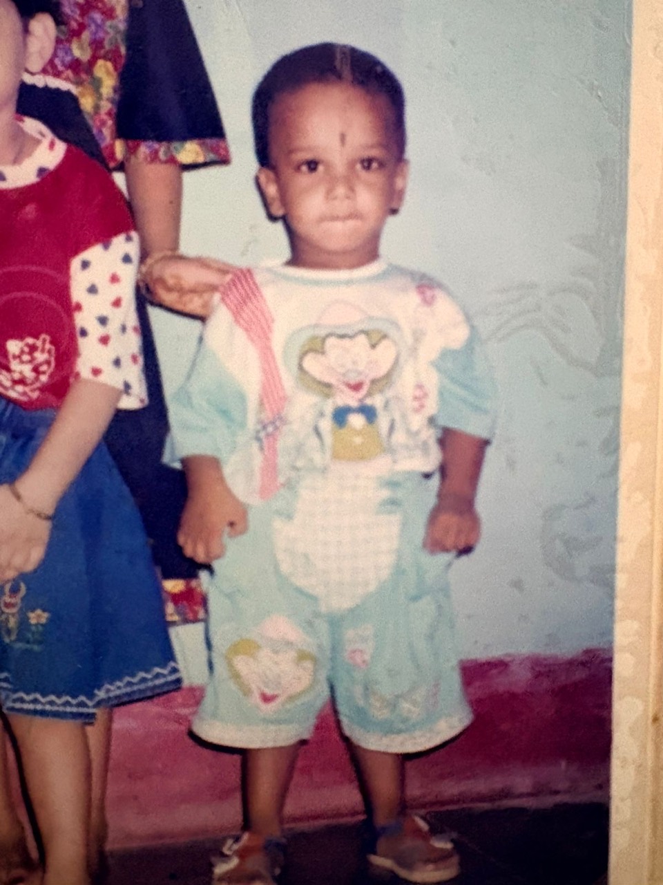 Original childhood photo of me in a mint blue outfit