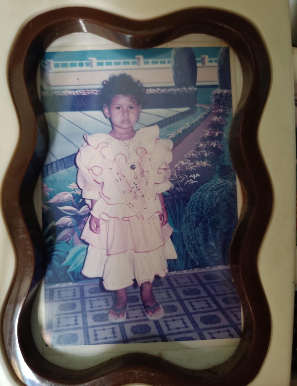 Original childhood photo of my wife in a pink frilly dress