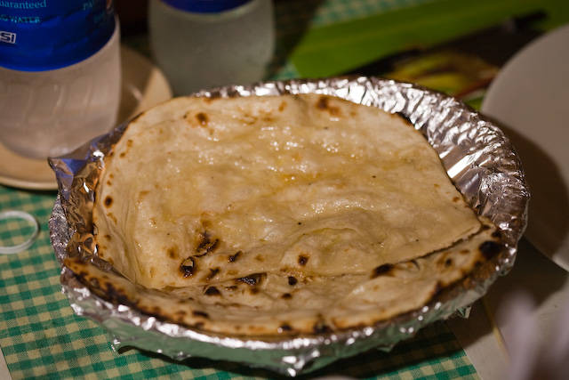 Butter naan on a plate.